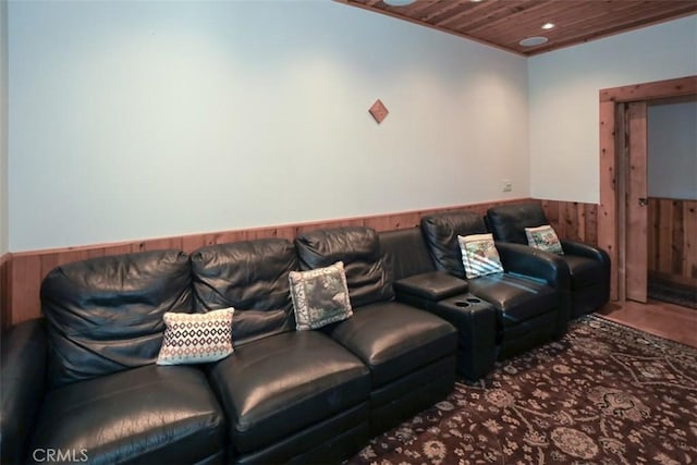 home theater room featuring wood ceiling and wooden walls