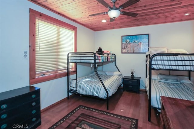 bedroom with ceiling fan, dark hardwood / wood-style flooring, and wood ceiling