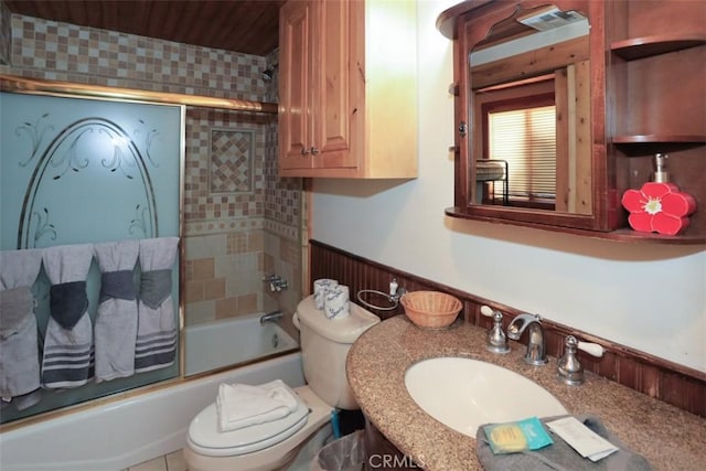 full bathroom with sink, enclosed tub / shower combo, and toilet