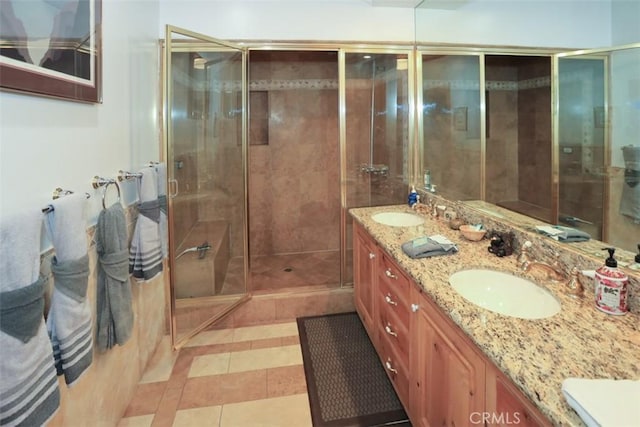 bathroom featuring tile patterned floors, walk in shower, and vanity