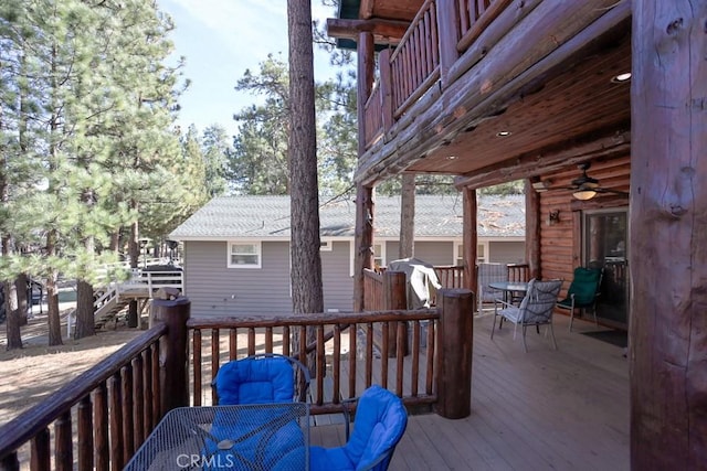 wooden deck featuring ceiling fan