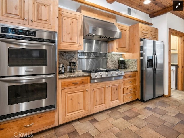 kitchen with wooden ceiling, appliances with stainless steel finishes, backsplash, wall chimney range hood, and beam ceiling