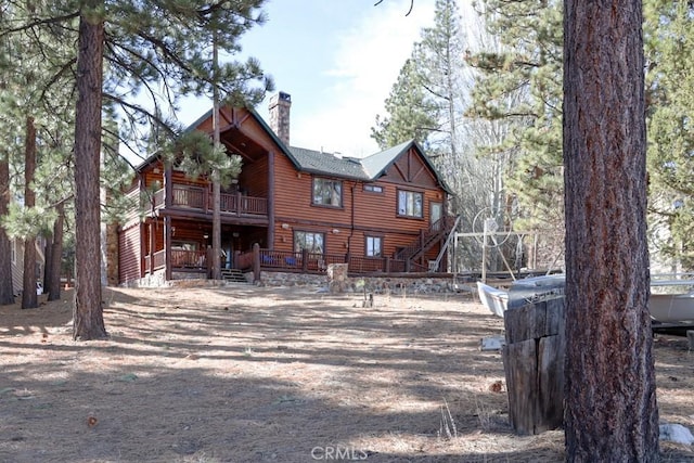 back of property with a balcony