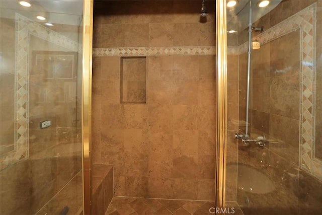 bathroom with a shower with door