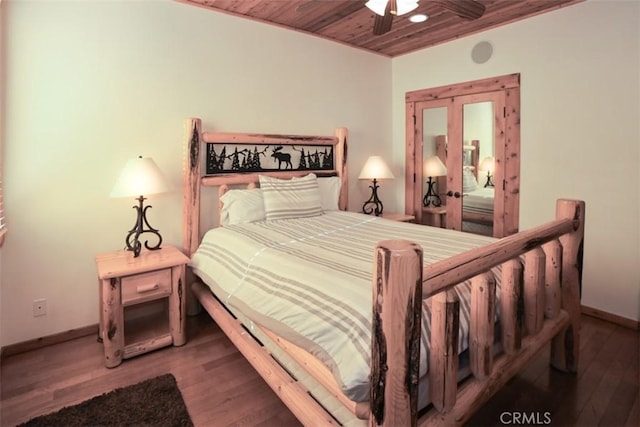 bedroom featuring ceiling fan, wood-type flooring, and wooden ceiling