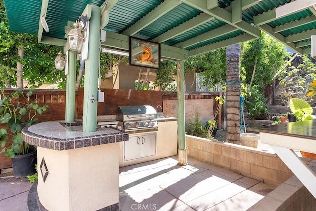 view of patio with sink and area for grilling