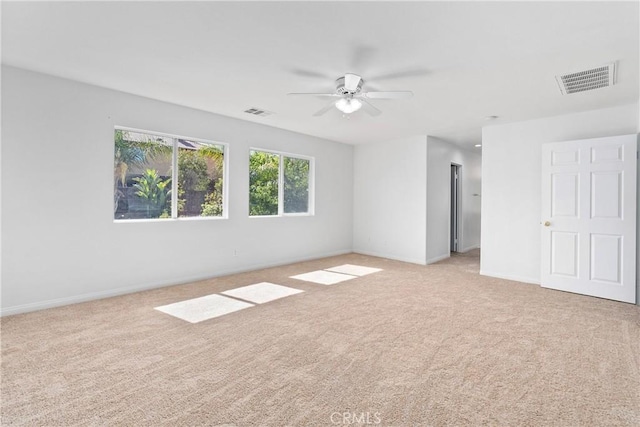 carpeted spare room with ceiling fan