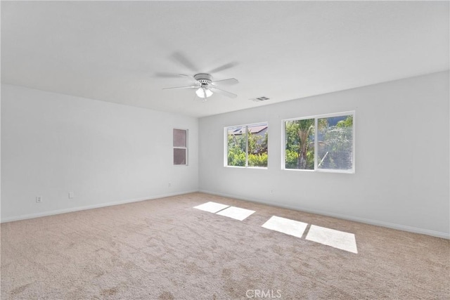 carpeted empty room featuring ceiling fan