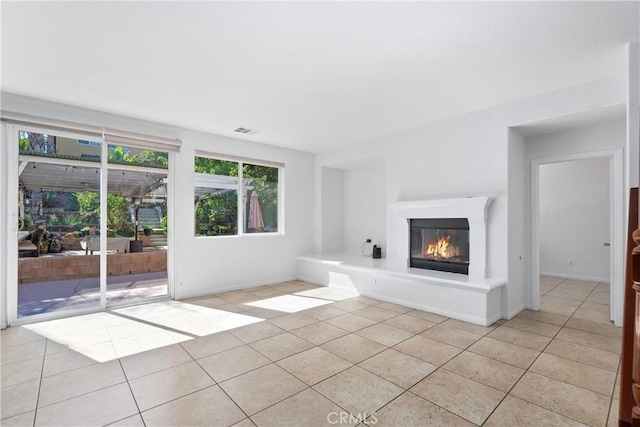 unfurnished living room with light tile patterned flooring