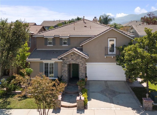 view of front facade with a mountain view and a garage