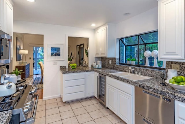 kitchen featuring white cabinetry, sink, and stainless steel appliances