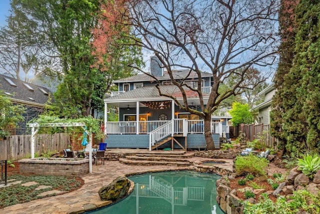 back of house with a patio, a pool side deck, and ceiling fan