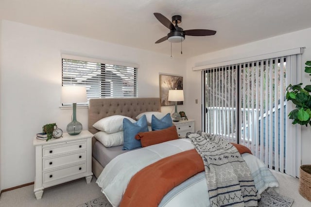 carpeted bedroom featuring access to exterior and ceiling fan