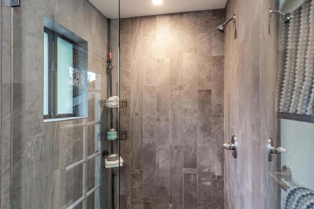 bathroom with a tile shower