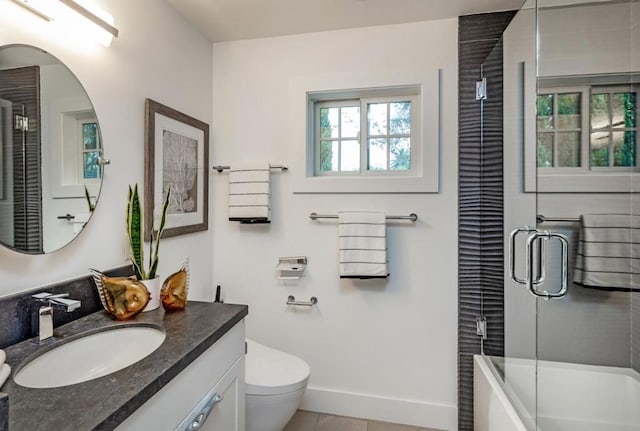 full bathroom with vanity, tile patterned floors, enclosed tub / shower combo, and toilet