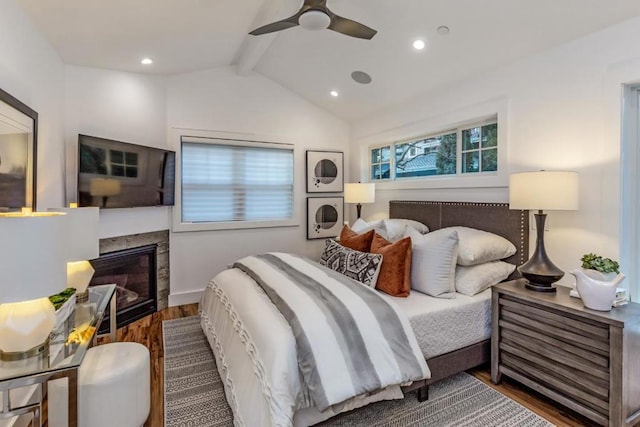 bedroom featuring hardwood / wood-style floors, lofted ceiling with beams, and ceiling fan