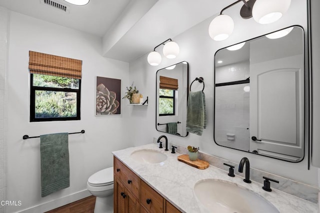 bathroom with vanity, hardwood / wood-style flooring, toilet, and plenty of natural light