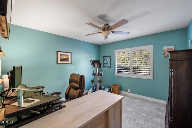 carpeted home office featuring ceiling fan