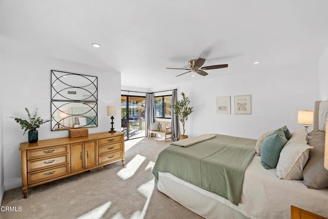 bedroom with access to outside, ceiling fan, and light colored carpet