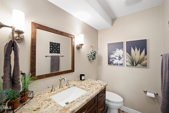 bathroom with vanity and toilet