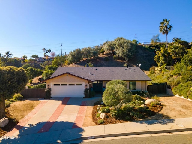 ranch-style home featuring a garage