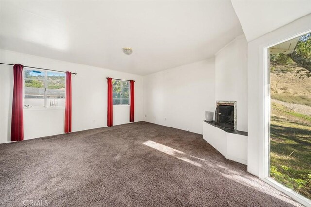 unfurnished living room featuring carpet flooring