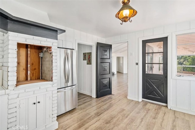 kitchen with stainless steel fridge and light wood-type flooring