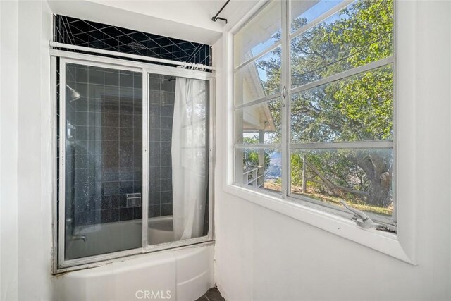 interior space with enclosed tub / shower combo