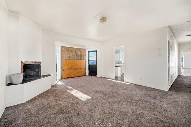 unfurnished living room with dark carpet