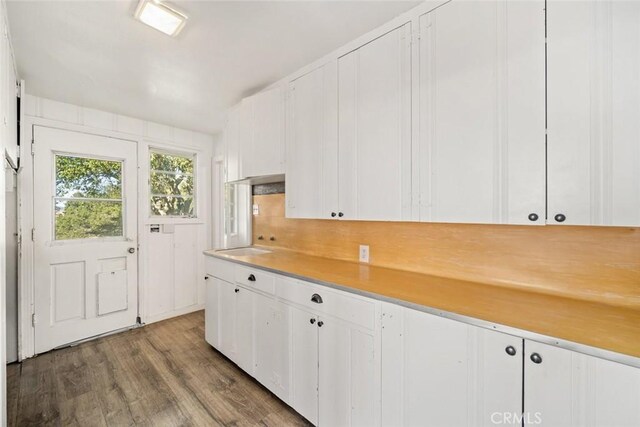 kitchen with white cabinetry and hardwood / wood-style floors