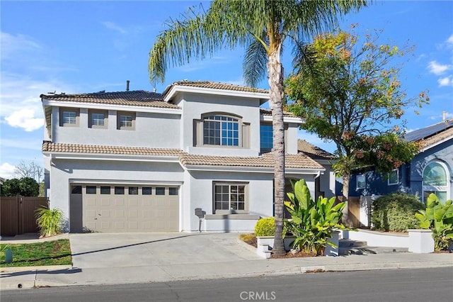 mediterranean / spanish-style home with a garage