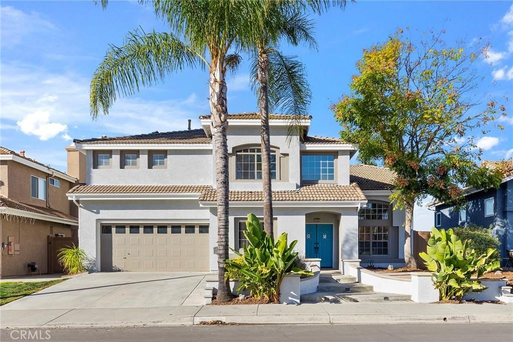 mediterranean / spanish house with a garage