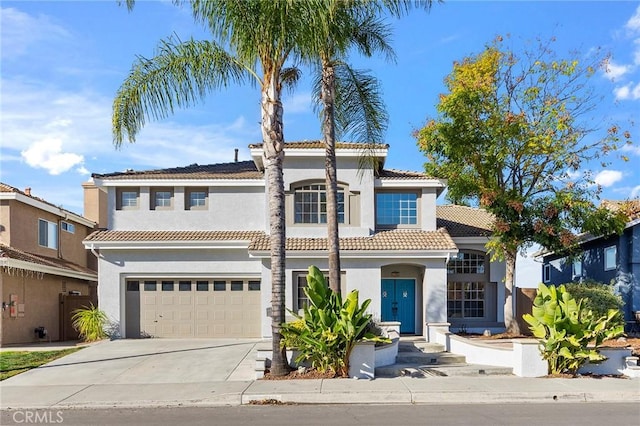 mediterranean / spanish house with a garage