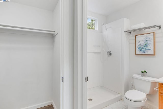 bathroom featuring toilet and a shower