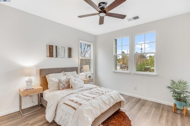 bedroom with light wood-type flooring and ceiling fan