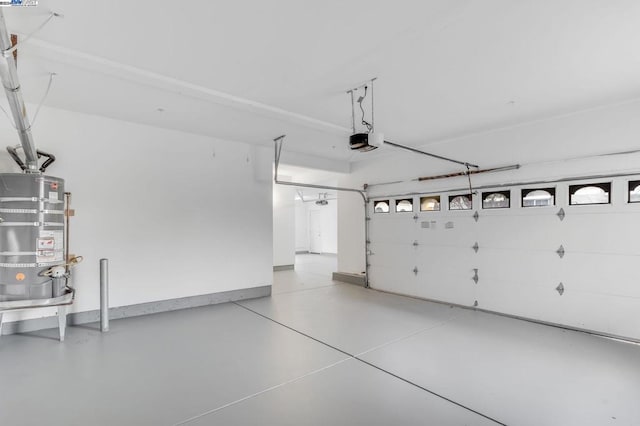 garage with secured water heater and a garage door opener