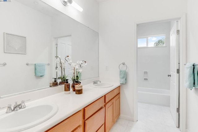 bathroom featuring vanity, a bathing tub, and tile patterned flooring