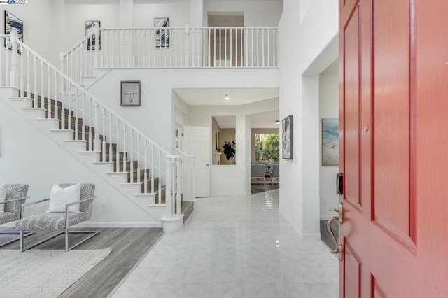 entryway featuring light hardwood / wood-style flooring and a high ceiling