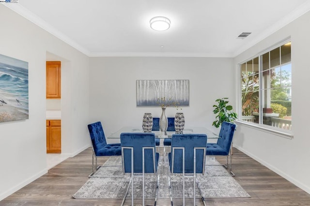 dining room featuring crown molding and hardwood / wood-style floors