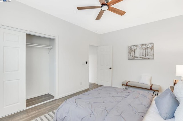 bedroom with ceiling fan, a closet, and hardwood / wood-style flooring