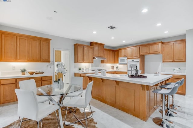 kitchen with a kitchen bar and a kitchen island