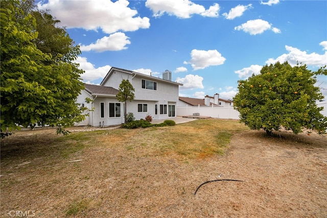 back of house with a yard