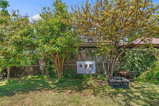 view of yard with an outdoor fire pit