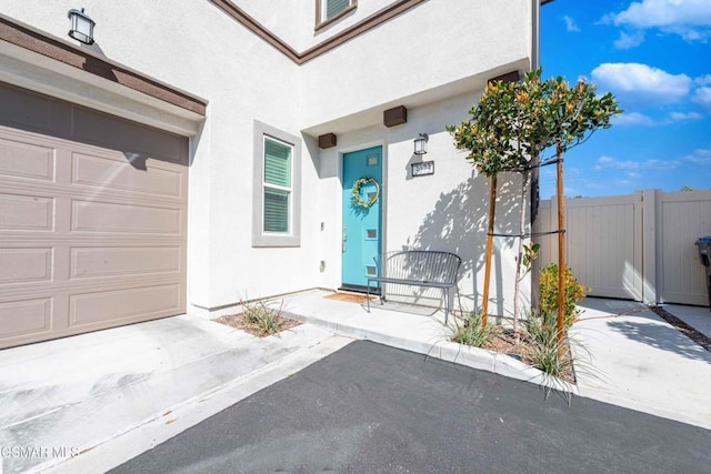 view of exterior entry with a garage