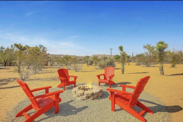 exterior space with a rural view and an outdoor fire pit