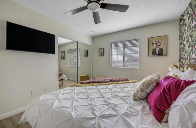 bedroom featuring a textured ceiling, a closet, and ceiling fan