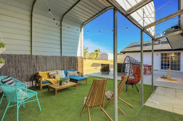 view of patio with a shed and outdoor lounge area