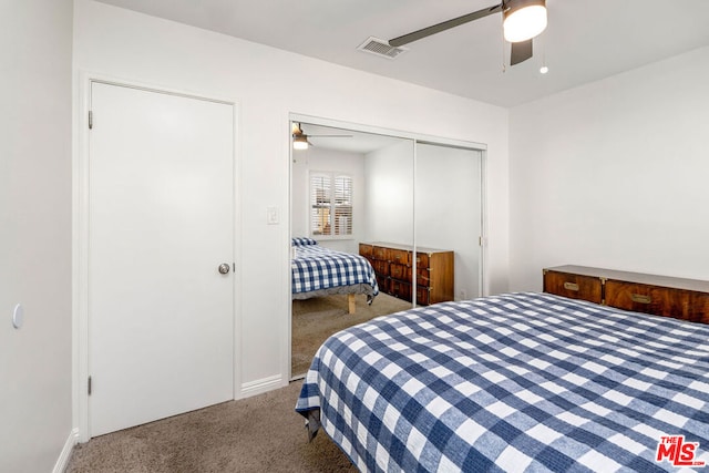 carpeted bedroom with ceiling fan and a closet