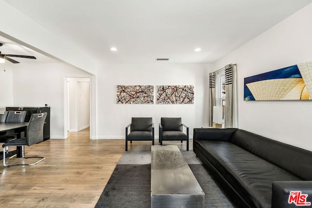 living room featuring hardwood / wood-style flooring and ceiling fan