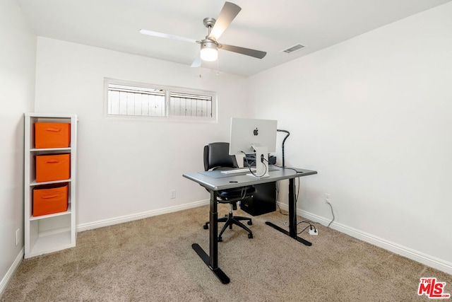 carpeted office space with ceiling fan